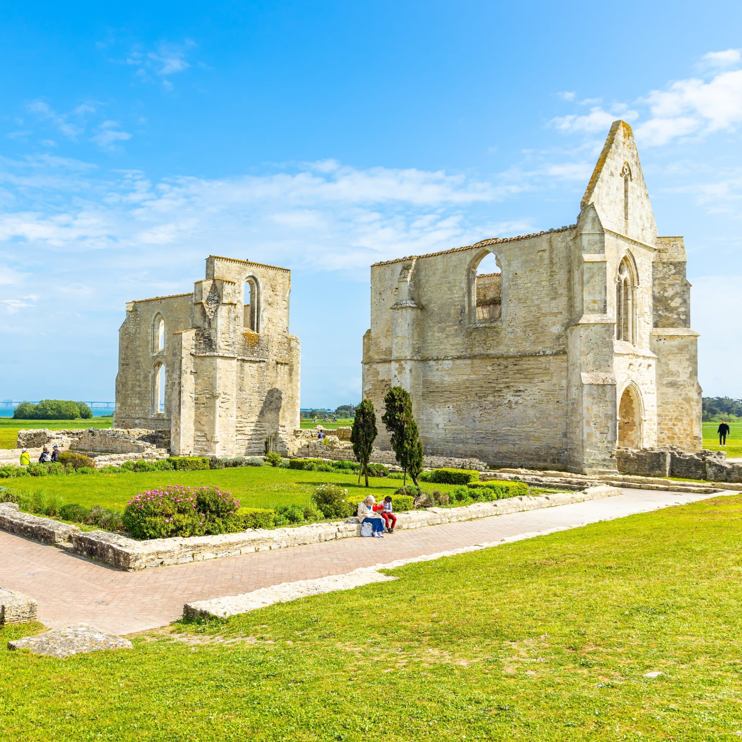 Ruines médiévales en pierre, ciel bleu, herbe verte